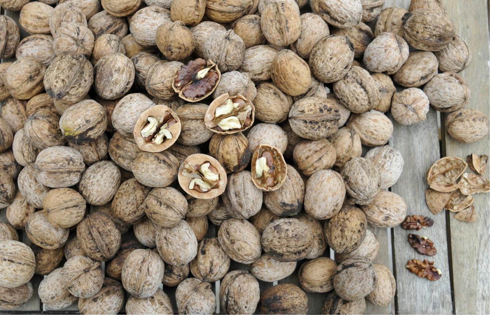 A pile of nuts sitting on top of a wooden table