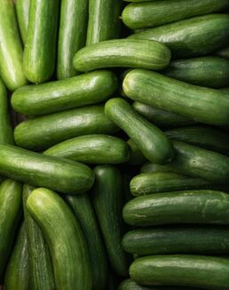 a pile of cucumbers sitting next to each other